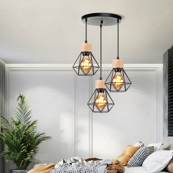 3-lamp pendant with wood and metal shade in a bedroom above a bed