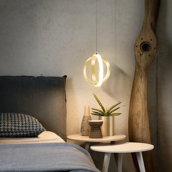 Ball-shaped designer bedroom pendant with 2 golden rings beside a bed