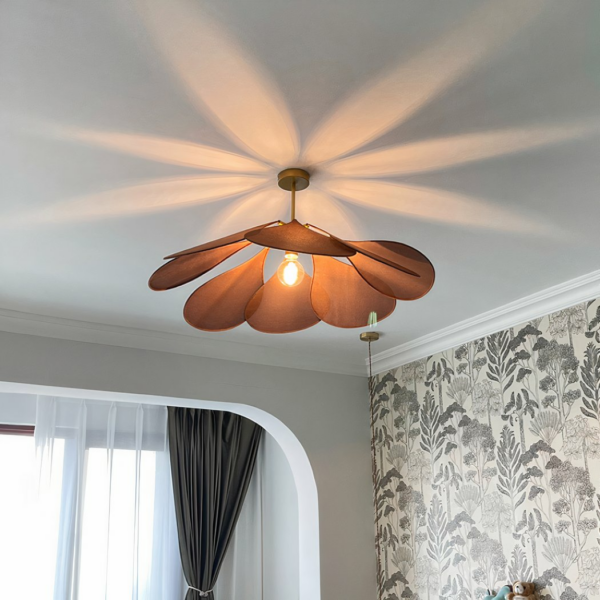 Bohemian-style fabric petal pendant displayed lit in a living room