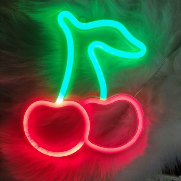 We can see a neon-style wall sconce in the shape of green and red cherries.