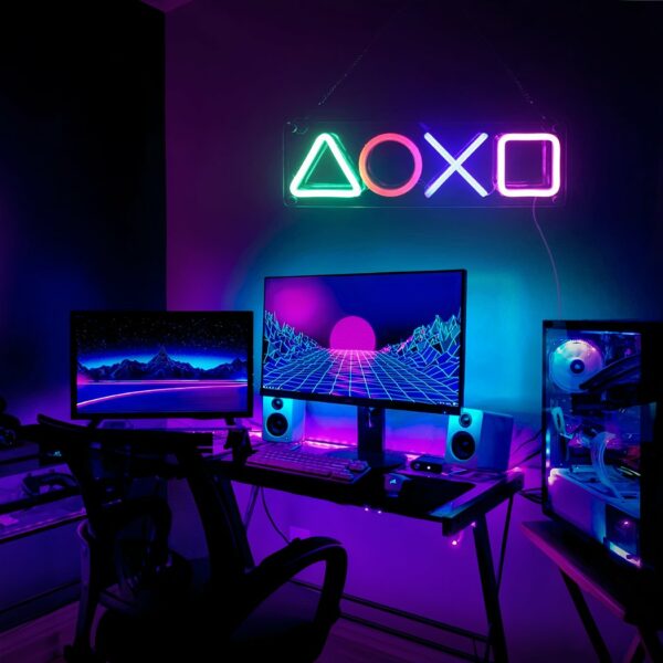 In a gamer's office, a futuristic neon wall light is lit on the wall.