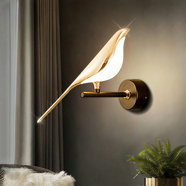 Against a black background, we see a golden wall sconce in the shape of a modern bird.