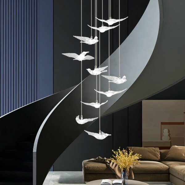 white LED bird chandelier in front of a staircase in a living room