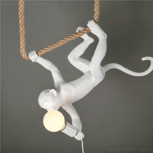 LED monkey hanging upside down from a lit rope