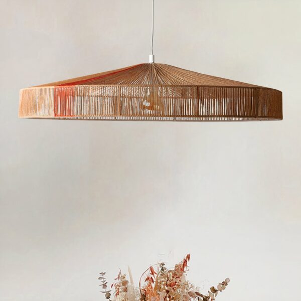 Flat handmade circular vintage hemp hanging above a plant