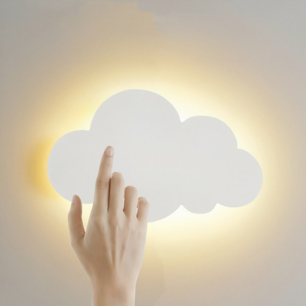 A white cloud-shaped wall sconce is lit on a white background, with a woman's hand on the cloud.