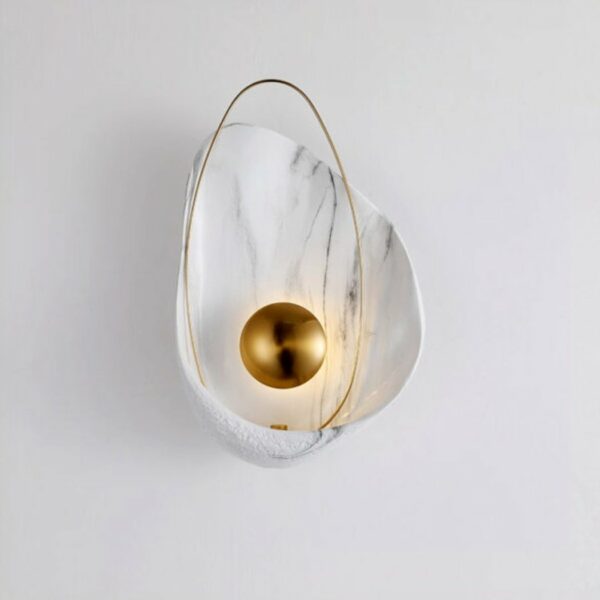 A white, marbled and gilded shell-shaped mural is set against a white background.