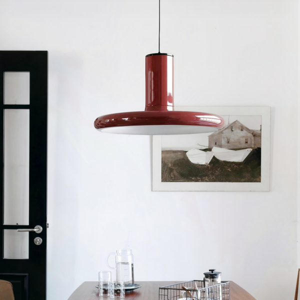Nordic-style terracotta suspension lamp in metal on a grey background with a picture and table in the center
