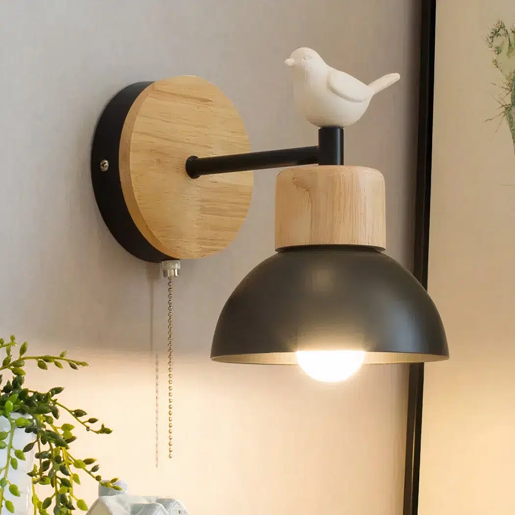 Nordic-style wall lamp with bird motif On one wall is a black Nordic-style wall sconce adorned with a white bird.