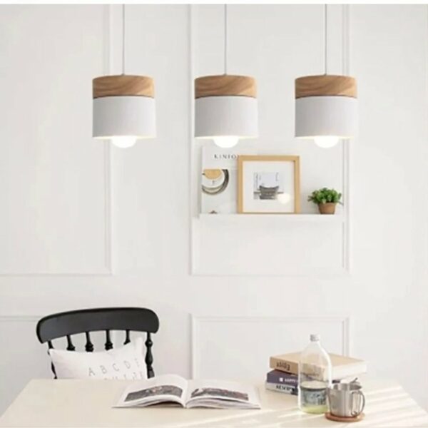 Scandinavian wooden pendant presented 3 times installed above a dining table