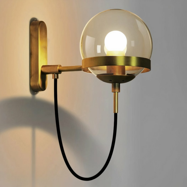 Golden LED wall light in a modern, minimalist design on a grey background