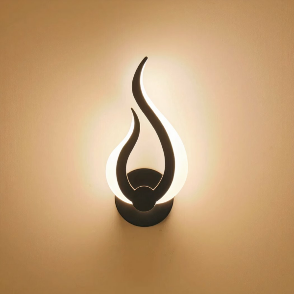 Modern-style LED wall light in the shape of a flame on a beige background