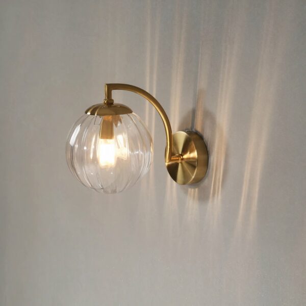 Nordic minimalist LED wall light in glass and metal on a grey background