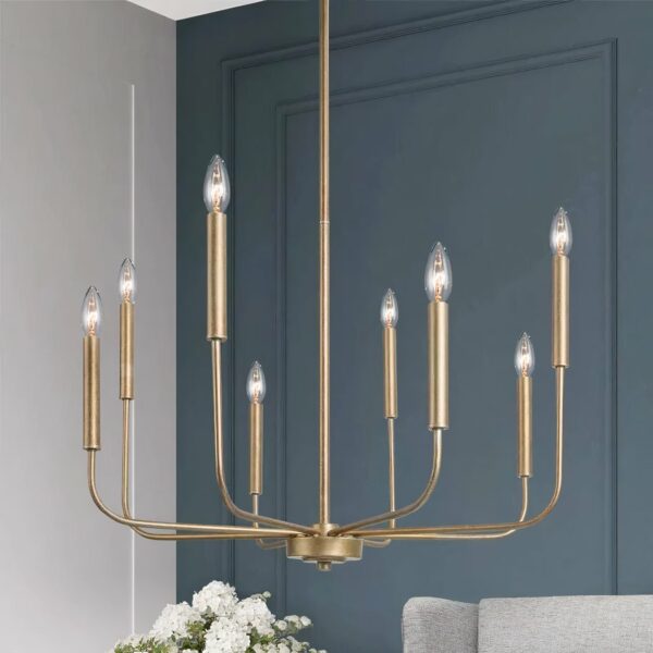 Gilded metal chandelier with 8 bulb candles. Behind, in the background, we see a duck-blue wall, a piece of white flower bouquet and a piece of light-gray sofa.