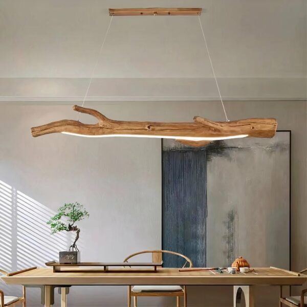 Branch chandelier with LED strip, suspended by two cables and connected to a rectangular base. White ceiling and white wall.