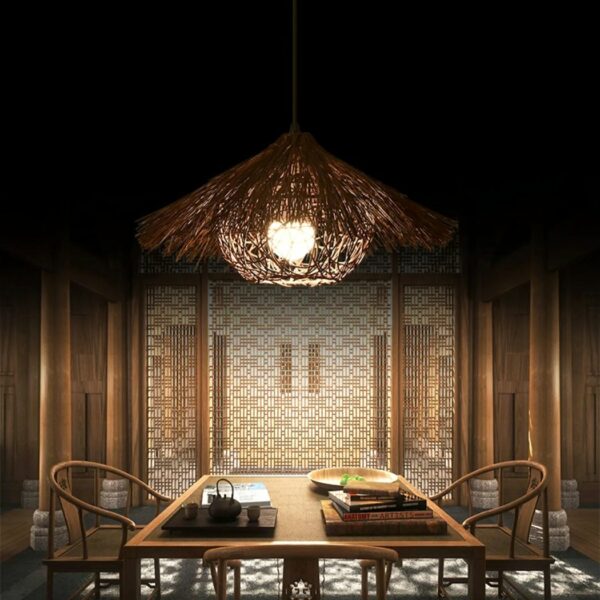 Colorful straw chandelier, exotic straw hut style, lit above a dining room table set for dinner.