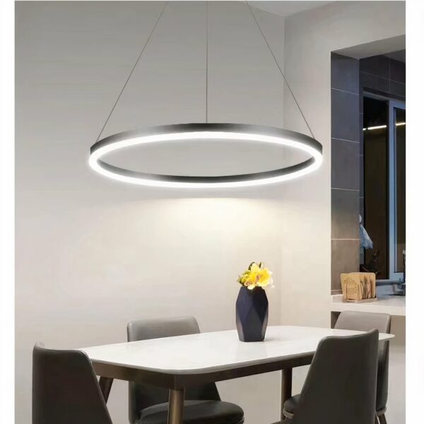 in a living room above a dining table, a circular LED suspension made of iron