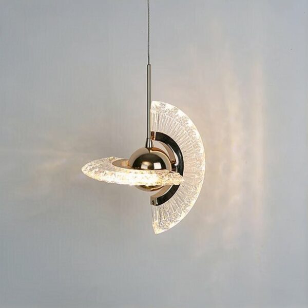 on a light grey background, we see a suspension in the shape of a rotating golden transparent planet