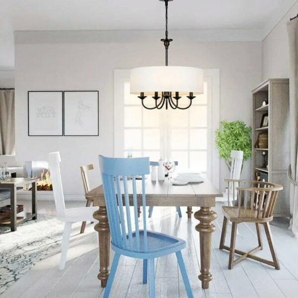 a black-and-white chandelier in the shape of a wrought-iron candlestick can be seen in a light-toned living room
