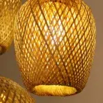 Close-up of the woven rattan lantern pendant shade with a lit bulb inside
