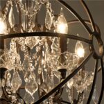 Detail of the cut crystal drops and lit candle bulbs within the orb frame