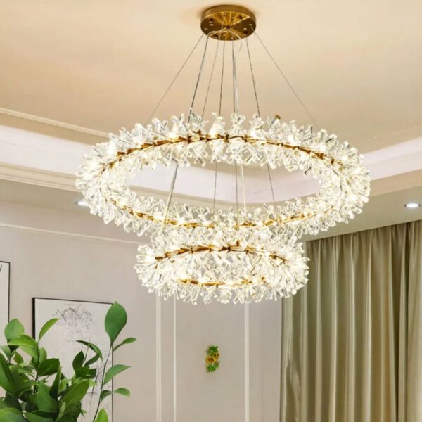 Bohemian LED chandelier in the shape of a wreath of flowers in a living room with a plant and a green curtain