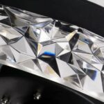 Close-up of the faceted crystal beads on a ceiling fan's light ring