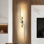 Zigzag linear LED wall light glowing on a wood slat wall panel