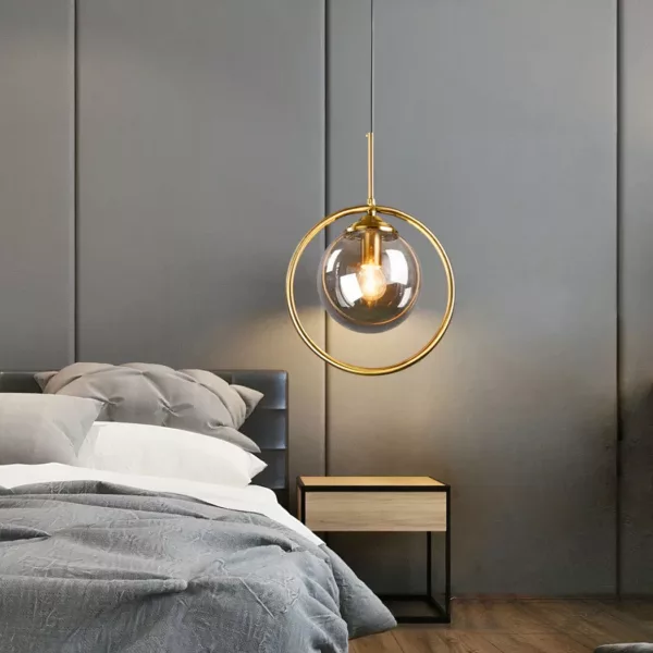 Modern Elegant Glass Globe Pendant Light Glass ball-shaped led lampshade hanging over a bed