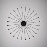 Black sunburst ceiling light with radiating rods tipped by small LED bulbs
