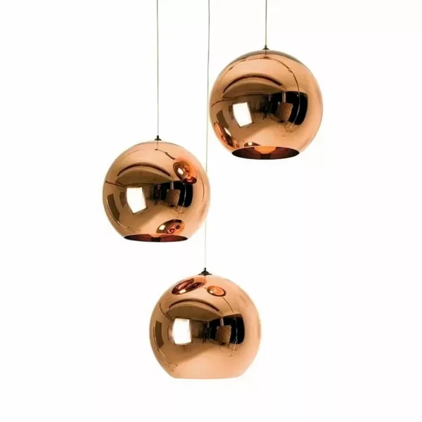 Three spherical pendant lights with a mirrored copper finish