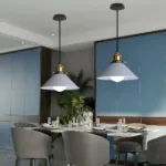 Same cone pendant lamps in a matching blue-grey finish above a dining table