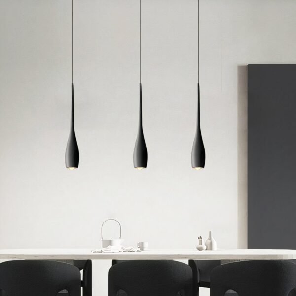 Modern black teardrop pendant presented in a dining room