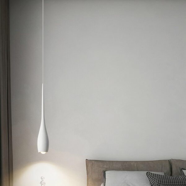 Modern black teardrop pendant presented in a dining room