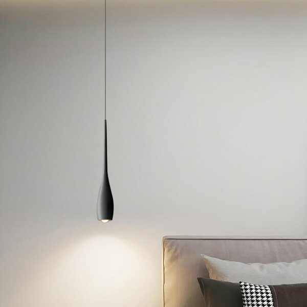 Modern black teardrop pendant presented in a dining room