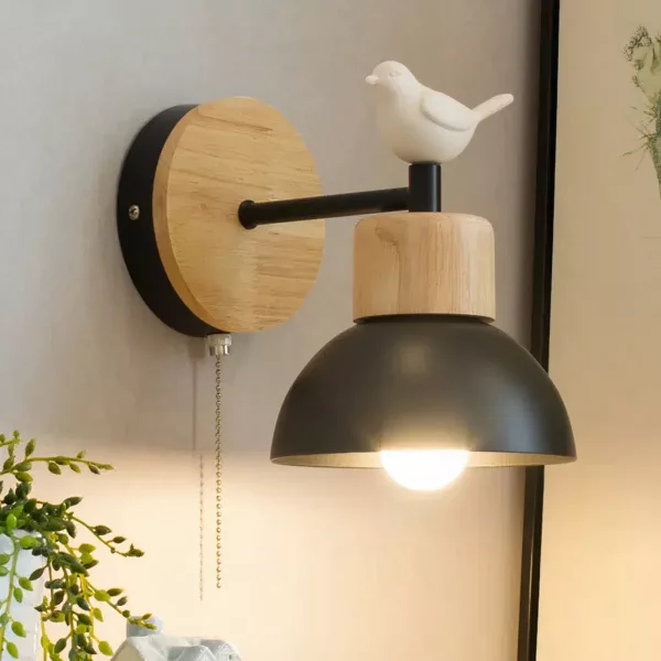On one wall is a black Nordic-style wall sconce adorned with a white bird.