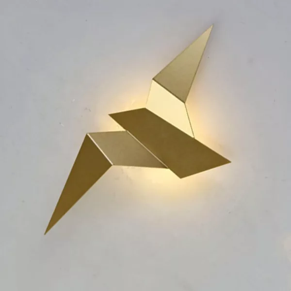 Origami Effect Flying Bird LED Wall Light A golden origami-style wall sconce in the shape of a bird is set against a white background.
