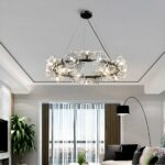 Dandelion-shaped LED chandelier above a living room with an arc floor lamp