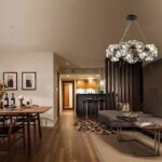 Dandelion-shaped LED chandelier lighting an open living and dining area