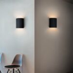 Split view of the black fluted wall light off in daylight and lit at night