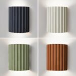 Four fluted Scandinavian double-light wall lamps in navy, cream, green and terracotta