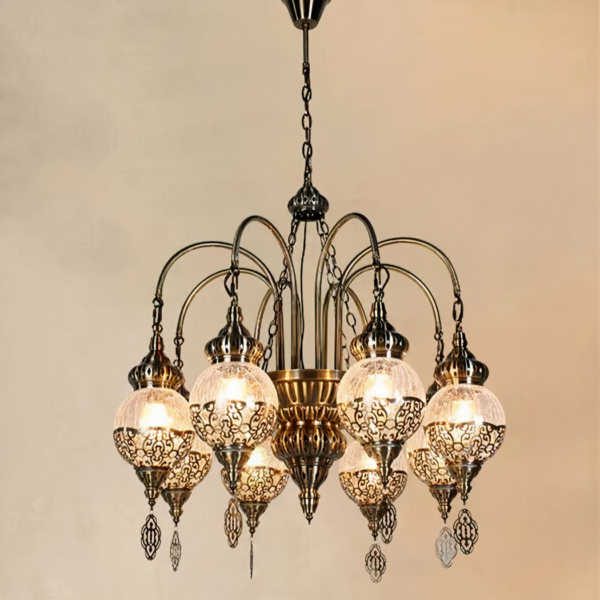 Moroccan chandelier in metal and cracked glass balls. Composed of 8 balls attached to the chandelier by curved arms. And each dressed in a kind of metallic embroidery. On a beige background.