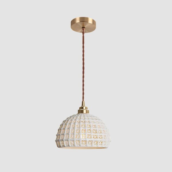 Original Scandinavian-design white pendant hanging from the ceiling and in front of a white wall.