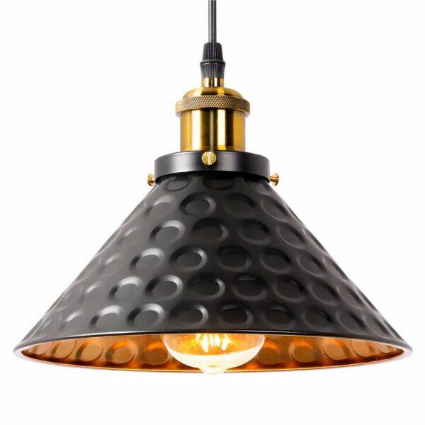Chandelier with metal shade. Black on the outside and gold on the inside with hammered round motifs. The top of the socket is gilded, the bulb is lit. White background.