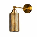 Gold wall light with a mesh cylinder shade on an articulated arm