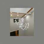 White branch shaped pendant chandelier glowing in a vaulted beamed ceiling room