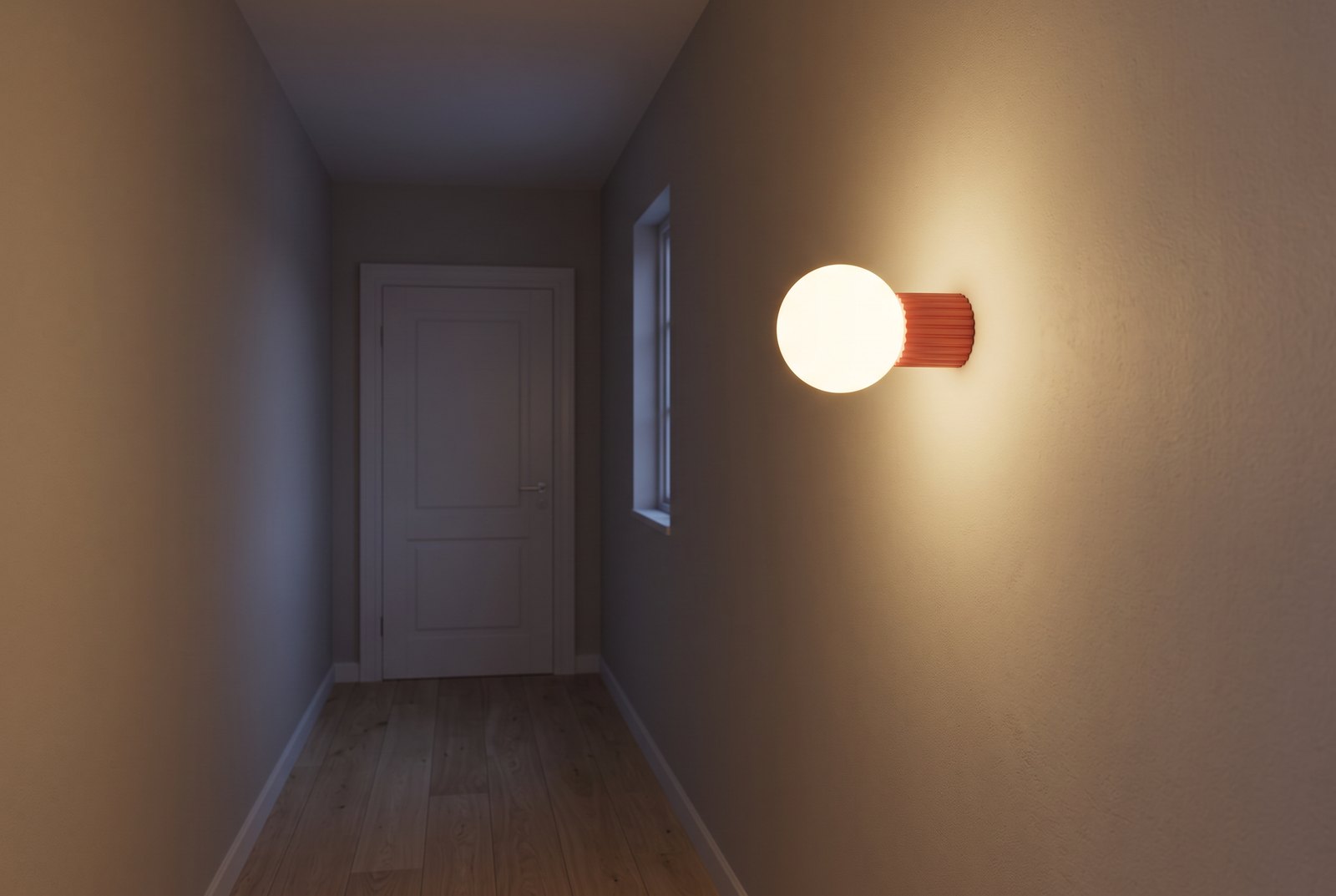 Wall light with a frosted glass globe and a coral ribbed aluminium base lit in a narrow hallway with a wooden floor, in the evening