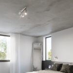 White three spotlight ceiling lamp in a bedroom with a large mirror