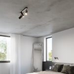 Black three spotlight ceiling lamp in a bedroom with a large mirror