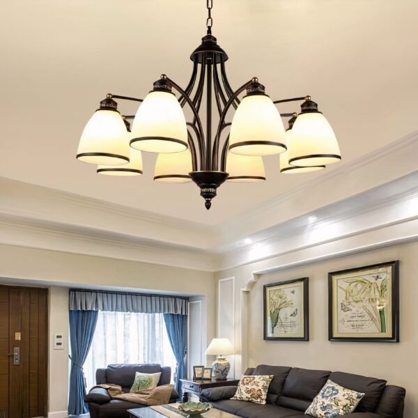 Bronze six arm chandelier with cream pleated fabric bell shaped shades